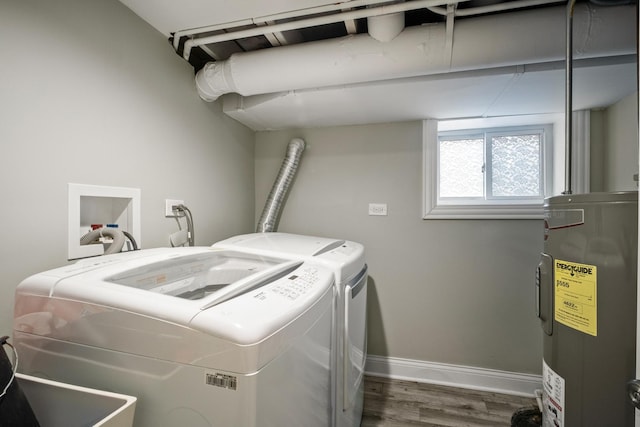 laundry area featuring separate washer and dryer, water heater, and hardwood / wood-style flooring