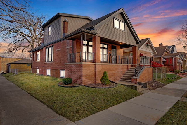 view of front facade with a lawn and a porch