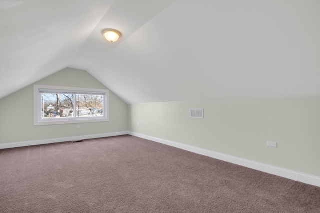 bonus room featuring carpet flooring and vaulted ceiling