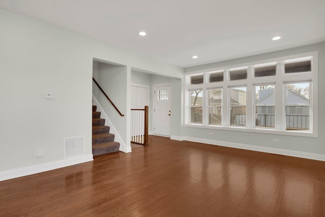 unfurnished living room with dark hardwood / wood-style floors