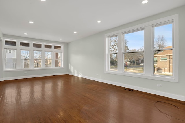 unfurnished living room featuring dark hardwood / wood-style floors