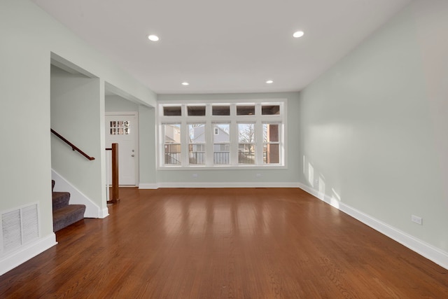 unfurnished living room with dark hardwood / wood-style flooring