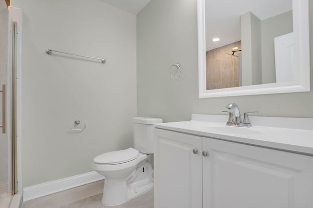 bathroom featuring tile patterned flooring, vanity, toilet, and a shower