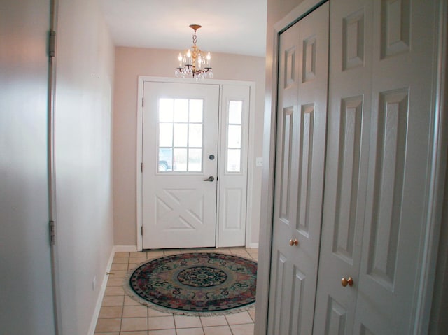 doorway with a notable chandelier and light tile patterned floors