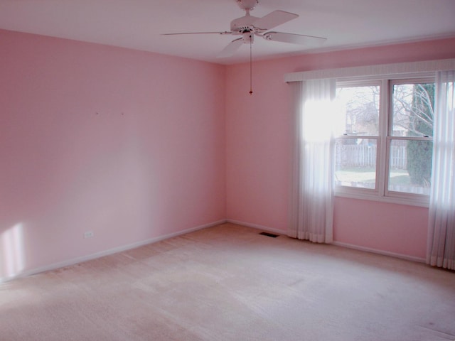 carpeted spare room with ceiling fan