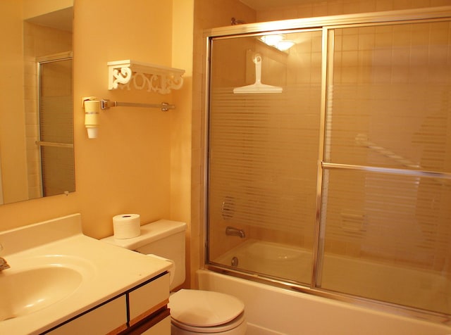 full bathroom with shower / bath combination with glass door, vanity, and toilet