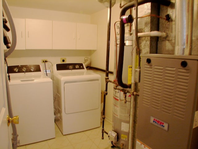 washroom featuring cabinets and independent washer and dryer