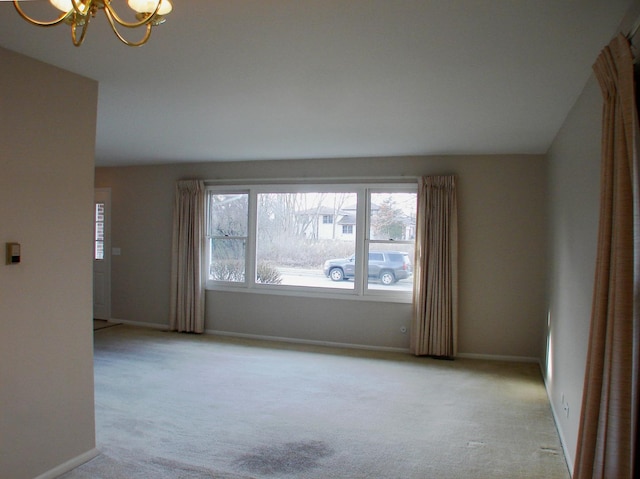 spare room with a notable chandelier, light carpet, and vaulted ceiling