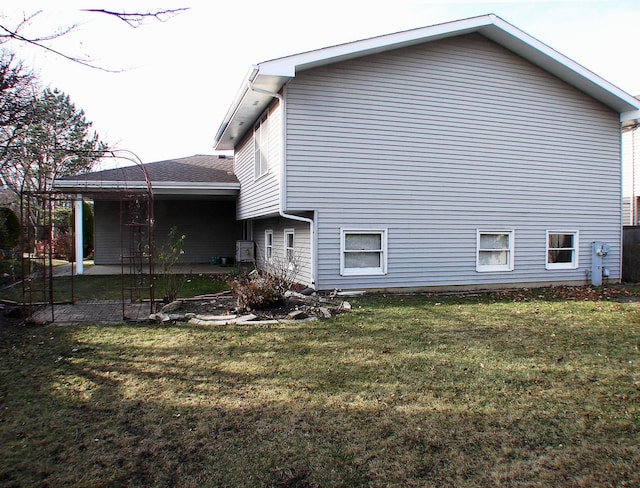 rear view of property with a lawn