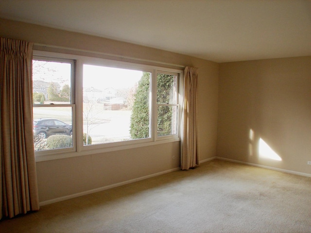 carpeted empty room with a wealth of natural light