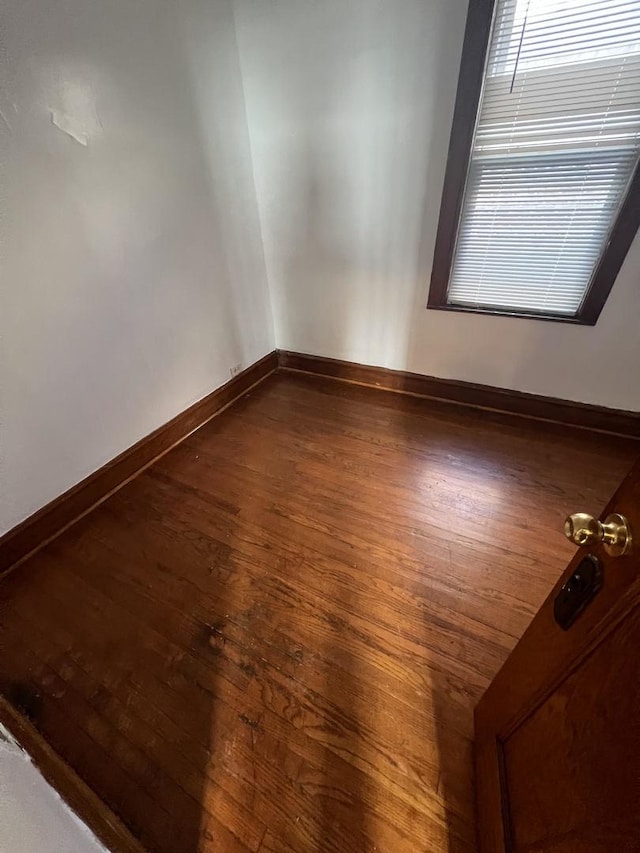 spare room with dark hardwood / wood-style floors