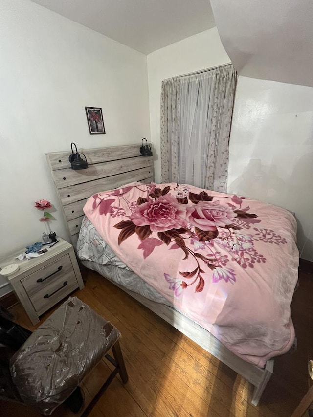 bedroom with dark wood-type flooring