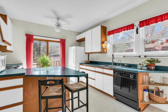 kitchen featuring white cabinetry, sink, black dishwasher, and white fridge