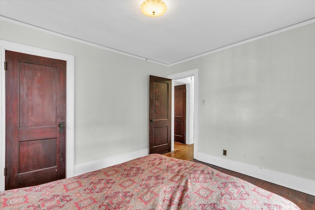 unfurnished bedroom featuring ornamental molding and hardwood / wood-style floors