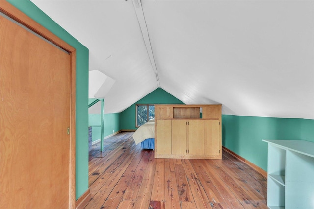 bonus room featuring vaulted ceiling and light wood-type flooring