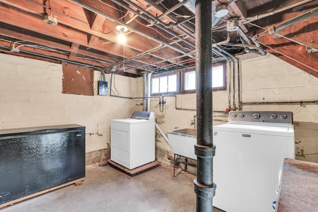 basement with washing machine and dryer and fridge