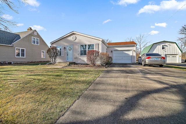 view of front of home with an outbuilding, a garage, and a front lawn