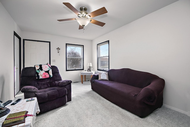 carpeted living room featuring ceiling fan