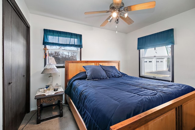 bedroom featuring carpet floors, a closet, multiple windows, and ceiling fan