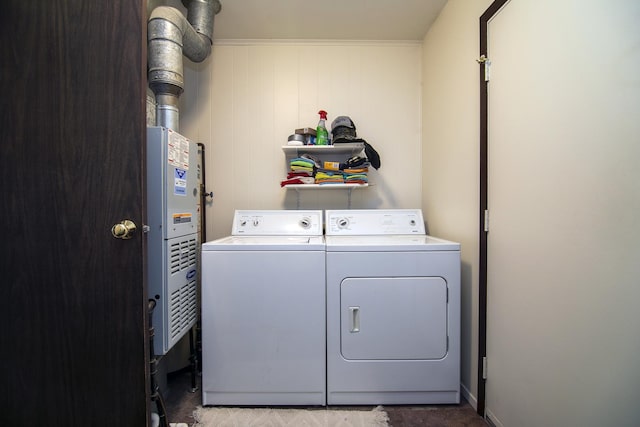 laundry room featuring washing machine and clothes dryer and wood walls