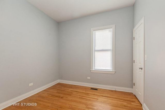 empty room with light hardwood / wood-style flooring