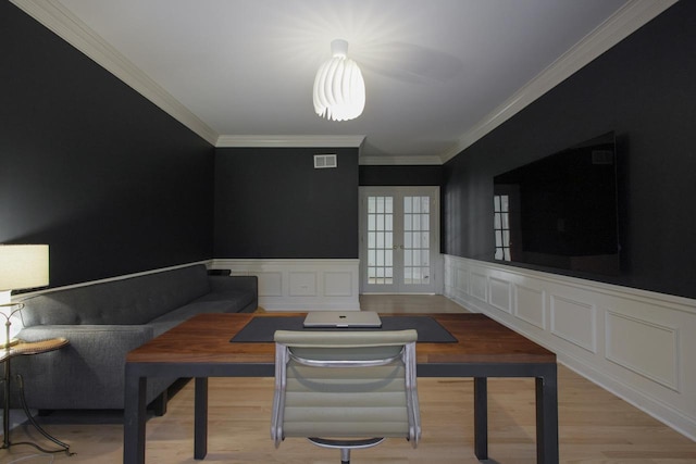 interior space featuring ornamental molding, french doors, and light wood-type flooring