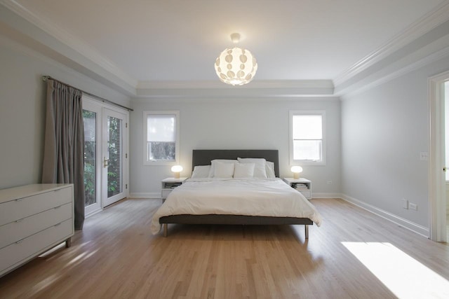 bedroom featuring multiple windows, light hardwood / wood-style flooring, and ornamental molding