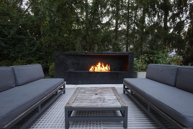 view of patio / terrace with an outdoor living space with a fireplace