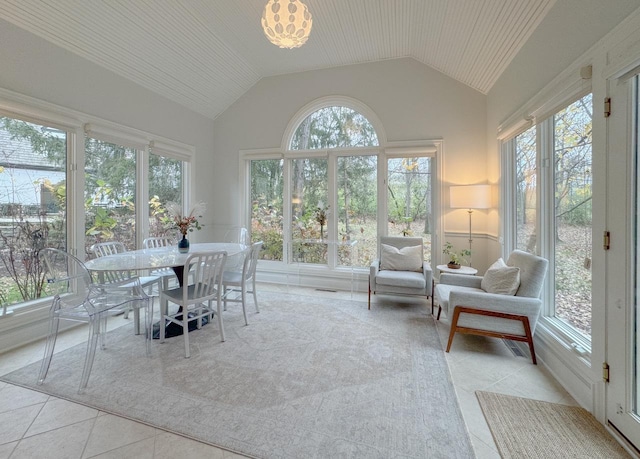 sunroom with a chandelier and vaulted ceiling