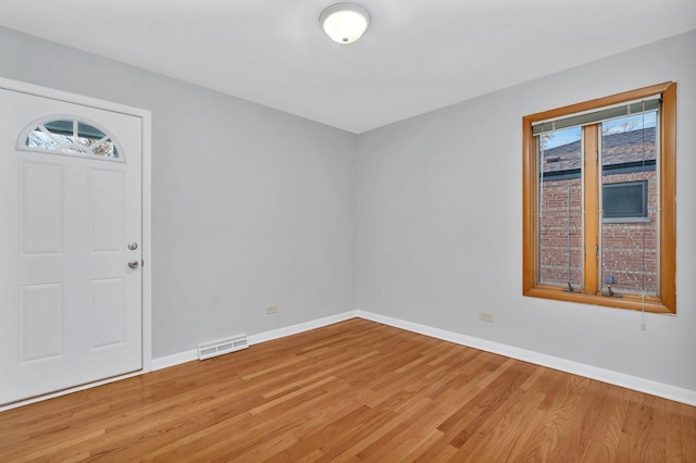 entryway with hardwood / wood-style flooring