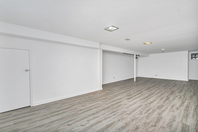 basement with light hardwood / wood-style floors