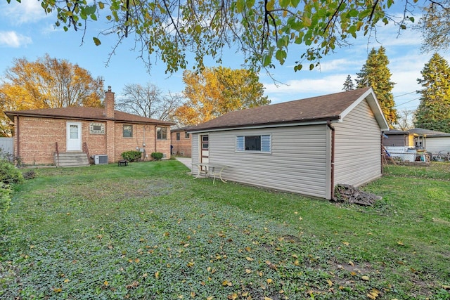 10016 Minnick Ave, Oak Lawn, IL 60453 - back of house with entry steps, an outbuilding, a chimney, brick siding, and a shingled roof