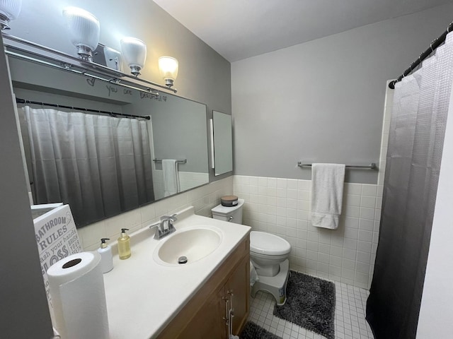 bathroom featuring walk in shower, tile patterned floors, toilet, vanity, and tile walls