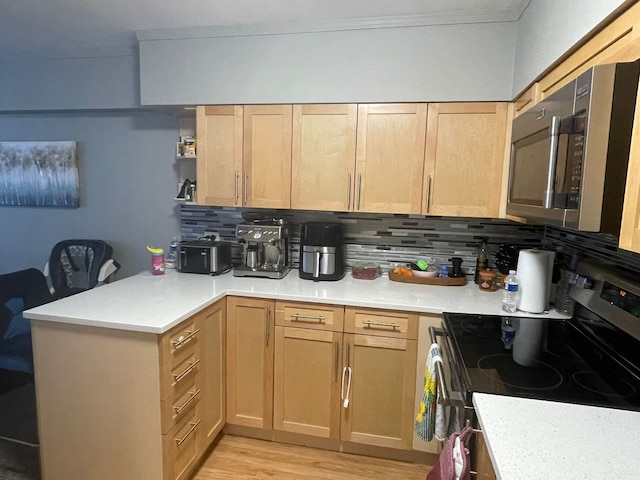 kitchen featuring light wood-type flooring, appliances with stainless steel finishes, backsplash, and light brown cabinetry