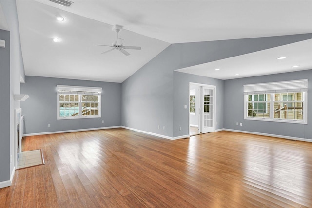 unfurnished living room featuring ceiling fan, light wood-type flooring, and vaulted ceiling