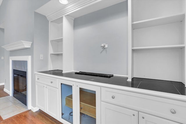 kitchen with hardwood / wood-style floors and white cabinets