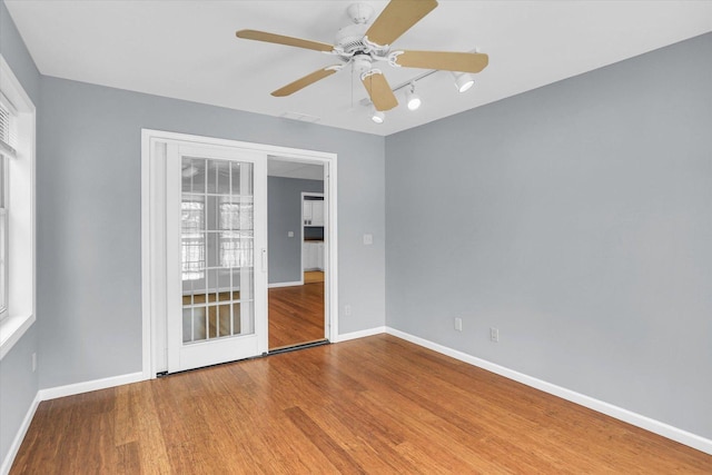 unfurnished room featuring hardwood / wood-style flooring and ceiling fan