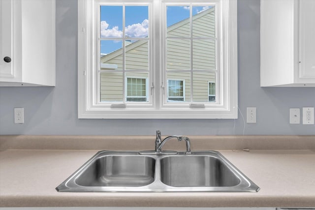 kitchen featuring white cabinets and sink