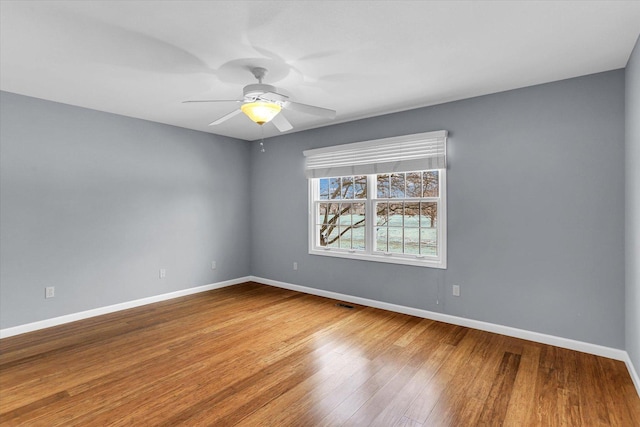 unfurnished room with ceiling fan and wood-type flooring