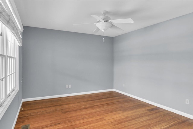 unfurnished room featuring hardwood / wood-style flooring, plenty of natural light, and ceiling fan