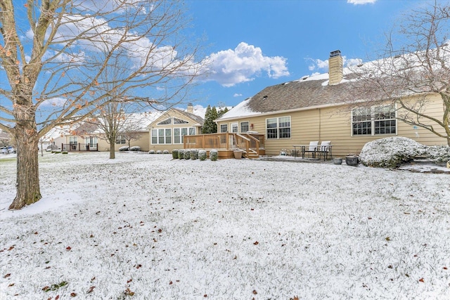 snow covered property with a deck