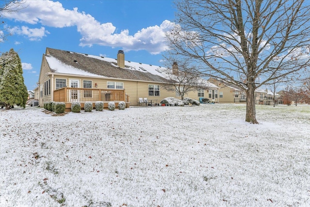 snow covered property featuring a wooden deck