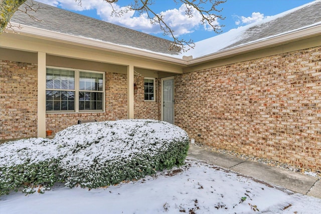 view of snow covered property entrance