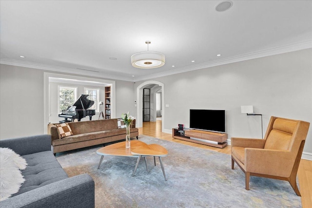 living room featuring ornamental molding and light wood-type flooring