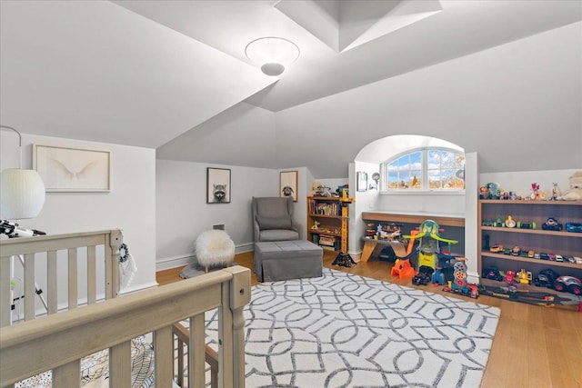 bedroom featuring hardwood / wood-style flooring and vaulted ceiling