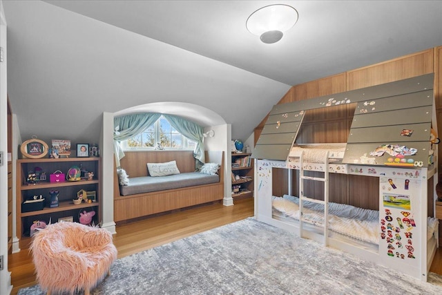 bedroom with vaulted ceiling and light hardwood / wood-style flooring