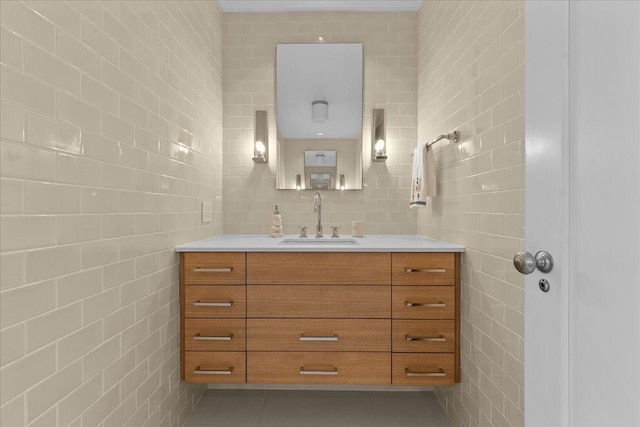 bathroom featuring tile patterned flooring, vanity, and tile walls