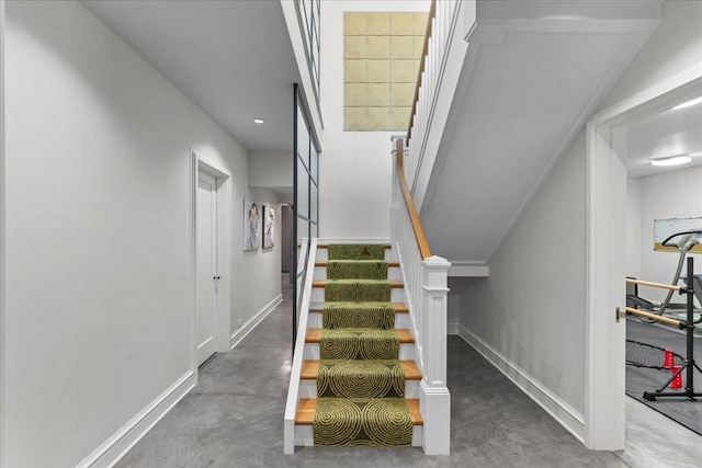 stairway featuring concrete flooring