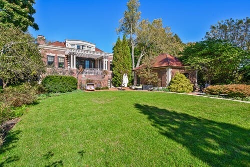 exterior space featuring a pergola and a front lawn