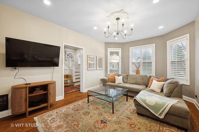 living room with hardwood / wood-style flooring and an inviting chandelier